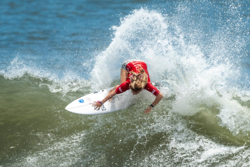 Charlotte Mulley surfing on a wave in the ocean