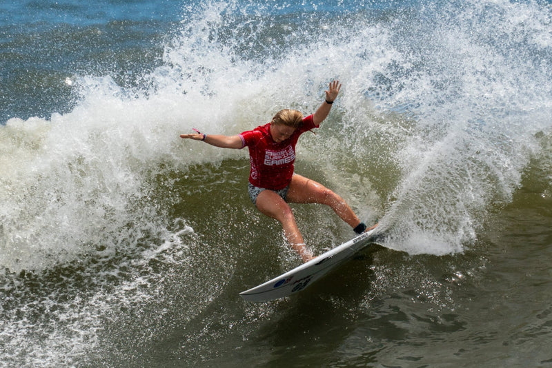Charlotte Mulley surfing on a wave in the ocean