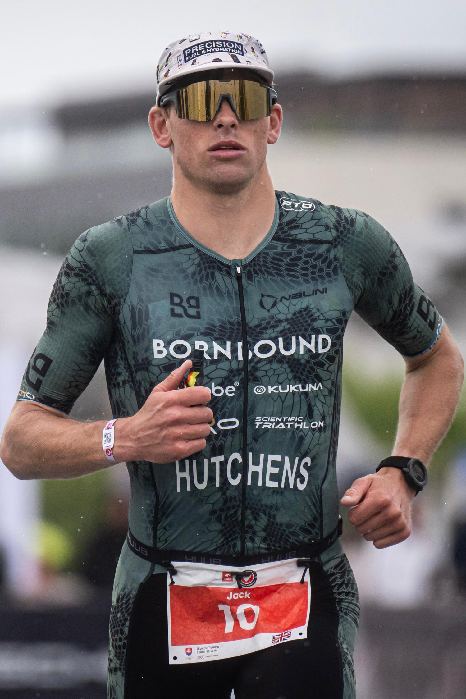 Jack Hutchens in a green triathlon suit with visible branding and race number.