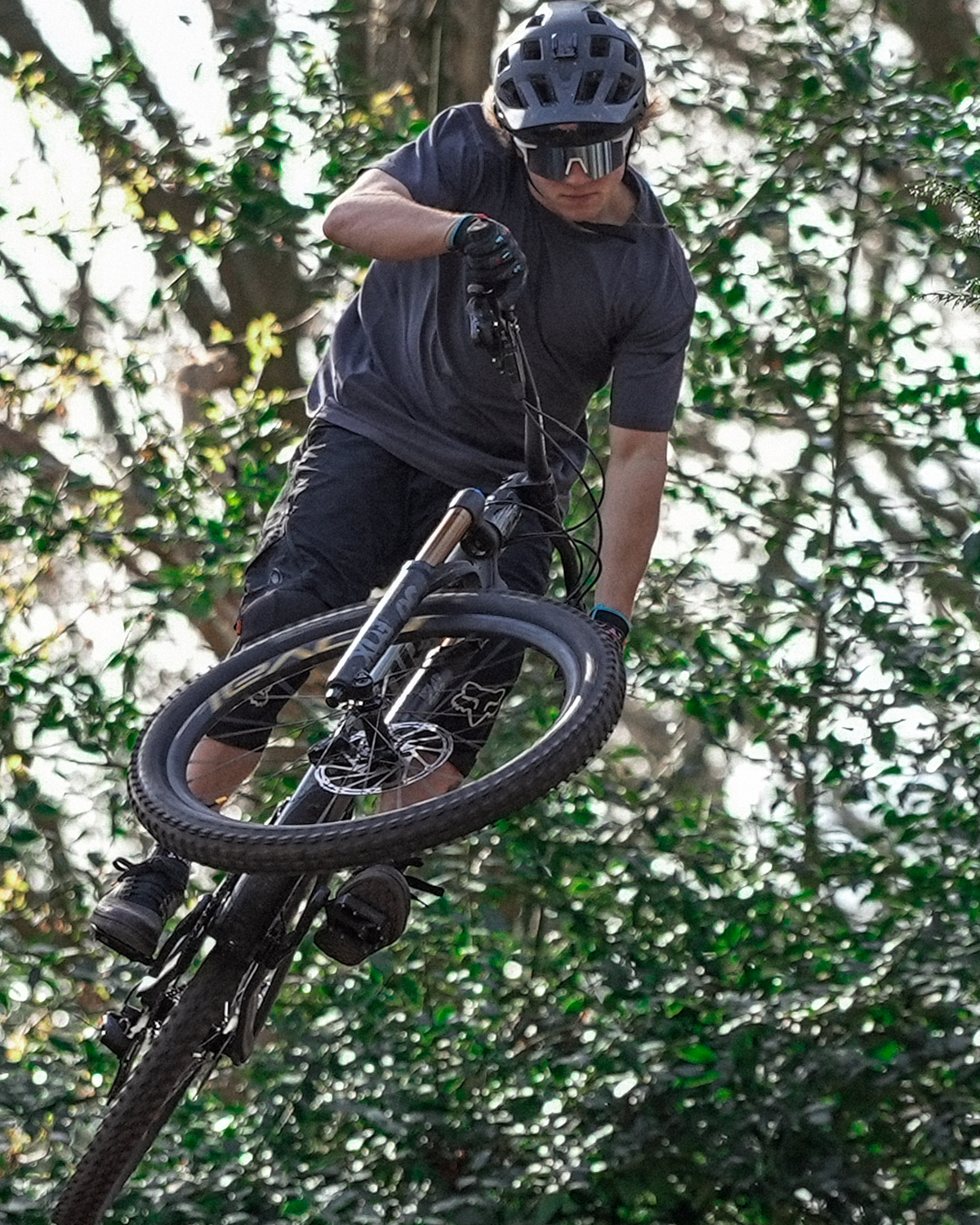 Person riding a mountain bike through a forest